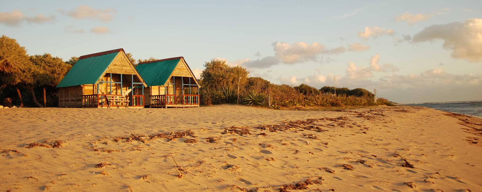 Romantic beach honeymoon bungalows at sunset in Lavanono, Madagascar