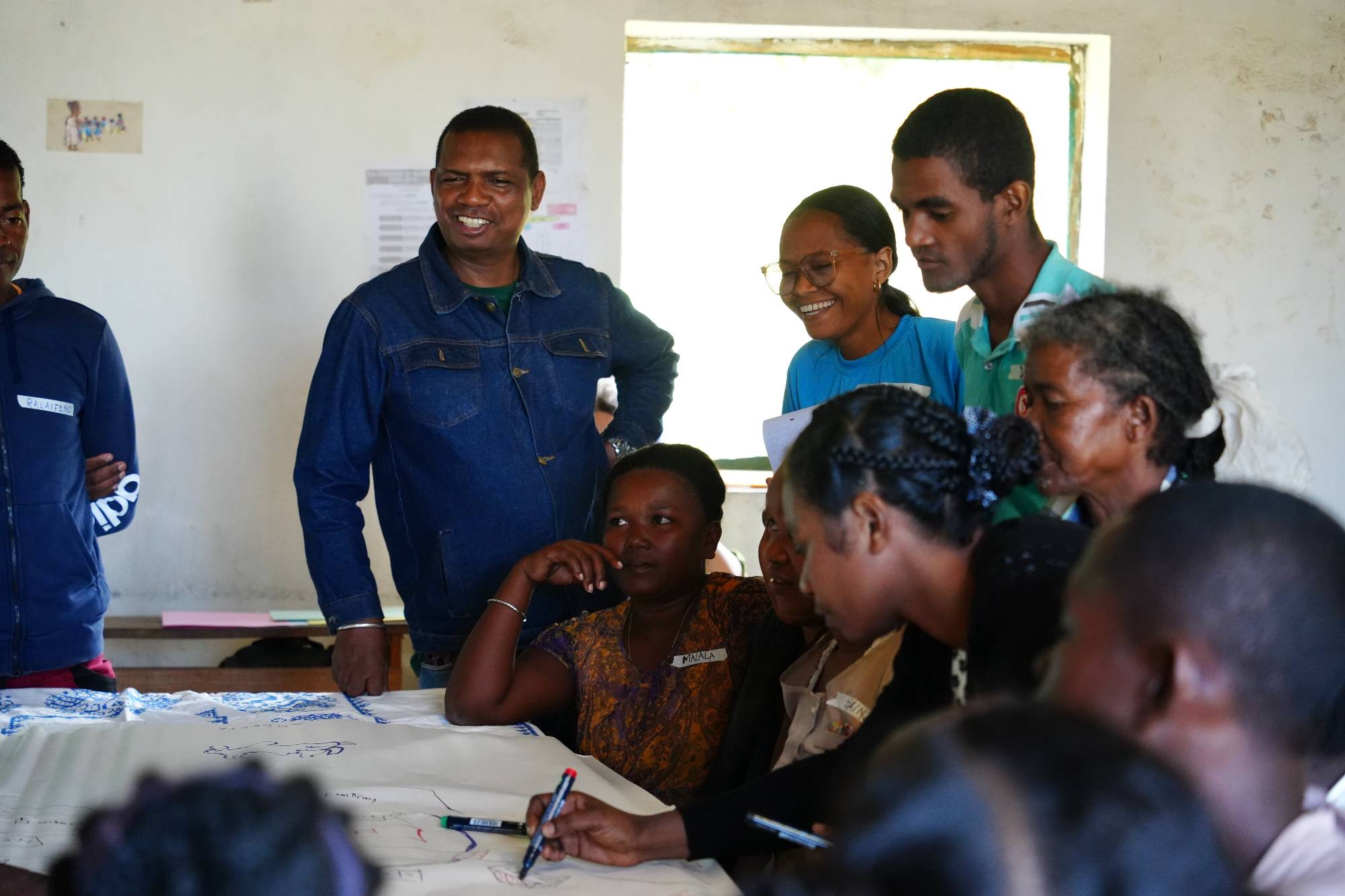 Theo facilitating the community mapping with the community.jpeg