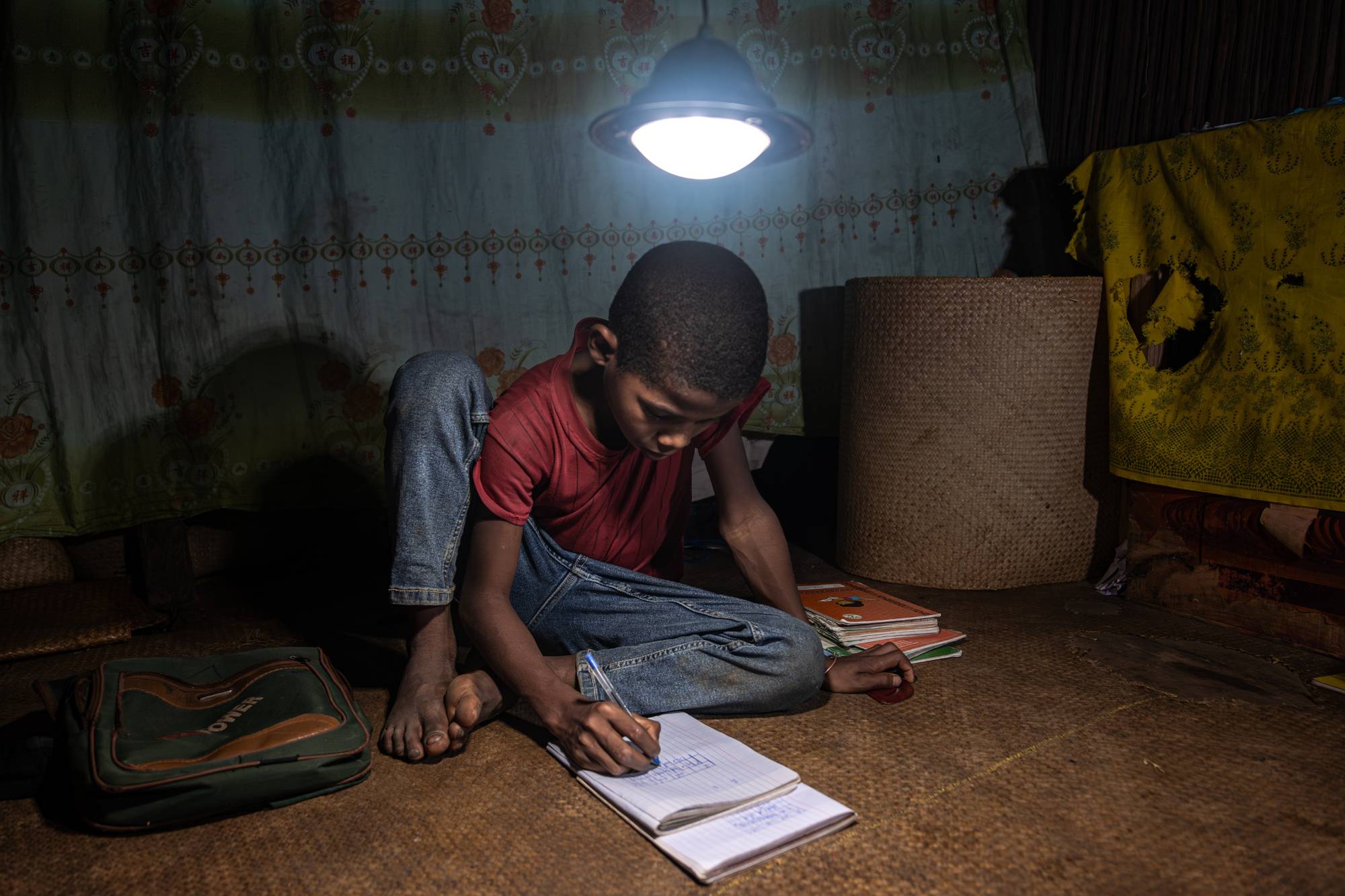 Student using solar lamp to help with homework
