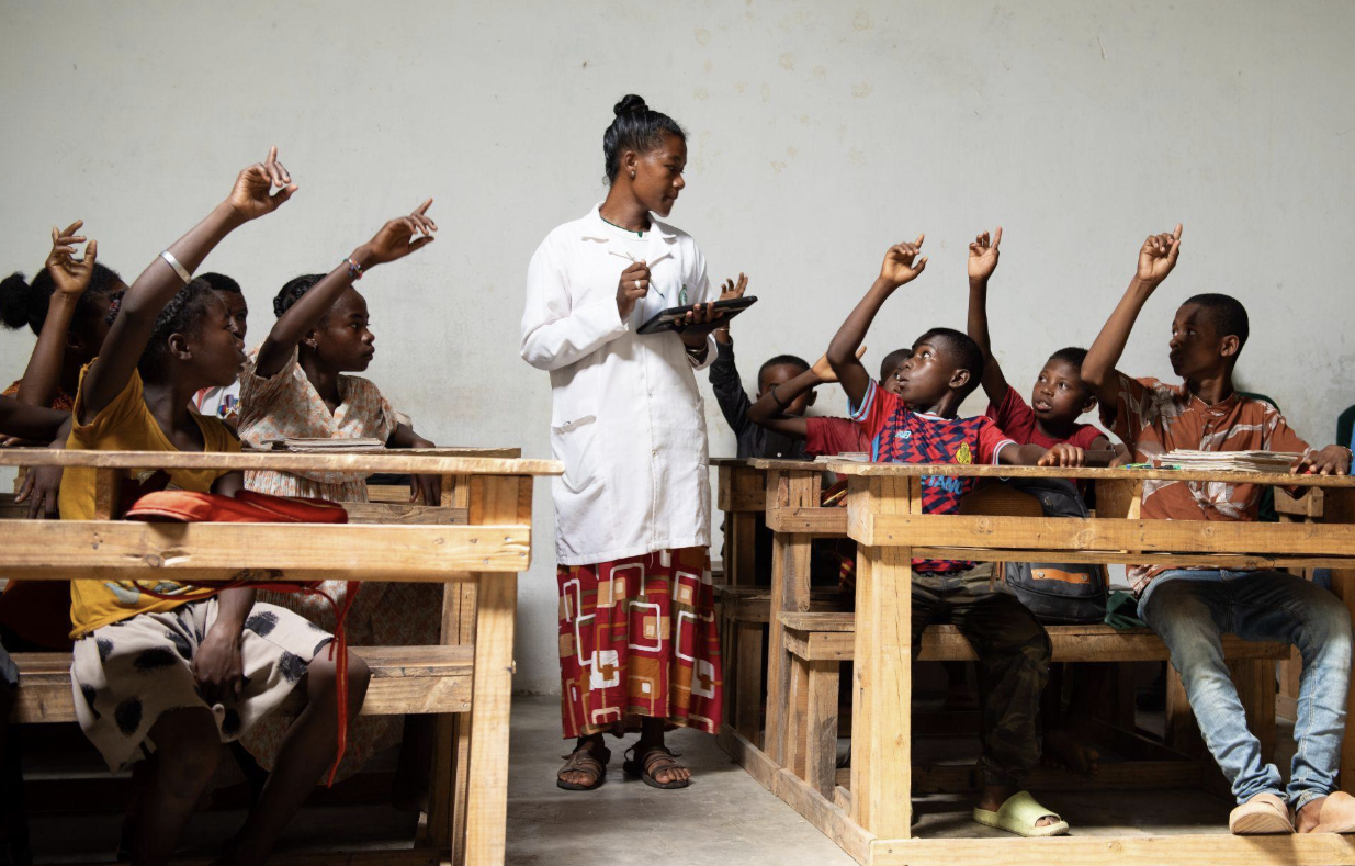 A teacher using a tablet to deliver a lesson in Primary School