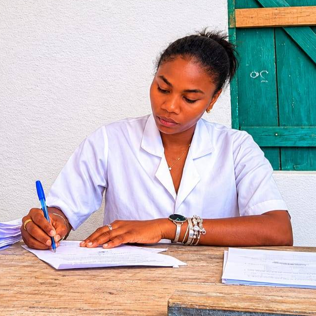 Flavine at a desk writing