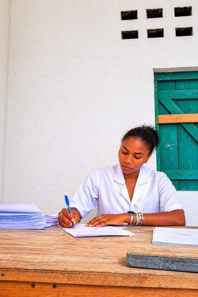 Flavine at a desk writing